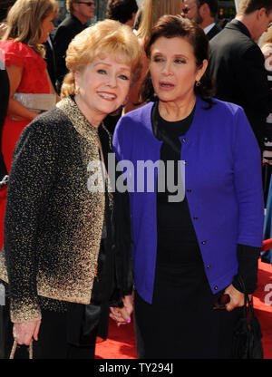 Singer Debbie Reynolds (L) and her daughter, actress Carrie Fisher arrive for the Primetime Creative Arts Emmy Awards at the Nokia Theatre in Los Angeles on September 10, 2011.  UPI/Jim Ruymen Stock Photo