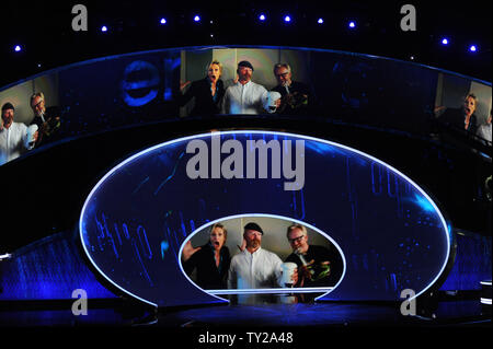 Host Jane Lynch performs with Mythbusters Jamie Hyneman (C) and Adam Savage on screen during the 63rd Annual Primetime Emmy Awards at the Nokia Theatre in Los Angeles on September 18, 2011.   UPI/Jim Ruymen Stock Photo