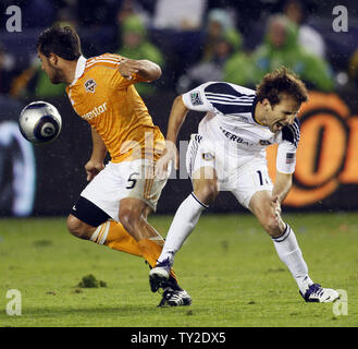 Houston Dynamo midfielder Danny Cruz, left, and Los Angeles Galaxy forward Mike Magee, right, battle for the ball in the first half of the MLS Cup at the Home Depot Center in Carson, California on Nov. 20, 2011.    UPI/Lori Shepler. Stock Photo