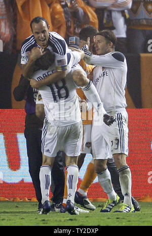 Los Angeles Galaxy's  Landon Donovan (10) , Mike Magee (18), and David Beckham (23) celebrate after they beat the Houston Dynamo in the second half of the MLS Cup at the Home Depot Center in Carson, California on Nov. 20, 2011. The Galaxy won 1-0.    UPI/Lori Shepler. Stock Photo