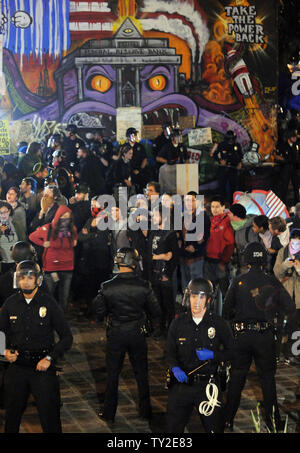 Angola Riot Police Two riot police officers move along a pavement past closed storefronts ...