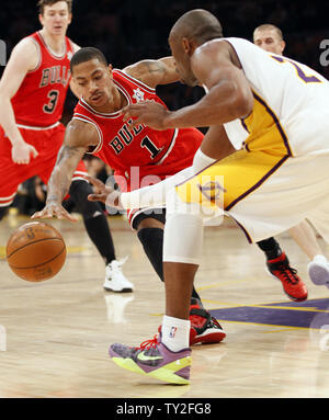 Chicago Bulls point guard Derrick Rose 1 keeps the ball away from Los Angeles Lakers shooting guard Kobe Bryant 24 in the second half of their NBA basketball game in Los Angeles