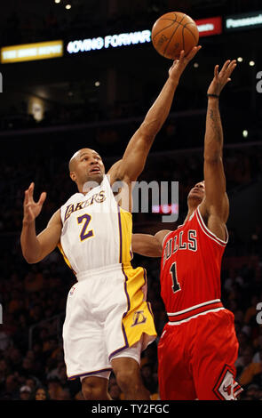 Los Angeles Lakers point guard Derek Fisher (2) makes a basket over Chicago Bulls point guard Derrick Rose (1) in the first half of their NBA basketball game in Los Angeles on December 25, 2011.    UPI/Lori Shepler Stock Photo