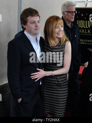 Actress Marg Helgenberger poses with her son Hugh Howard Rosenberg during an unveiling ceremony honoring her with the 2,458th star on the Hollywood Walk of Fame in Los Angeles on January 23, 2012. Actor Ted danson is pictured rear. UPI/Jim Ruymen Stock Photo