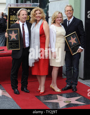 Dewey Bunnell (L) and Gerry Beckley (R), members of the classic rock group and Grammy Award-winning duo America, hold replica plaques after they were honored with the 2,459th star on the Hollywood Walk of Fame during an unveiling ceremony in Los Angeles on February 6, 2012. Bunnell and Beckley are pictured with their wives Penny (2nd-L) and Kathy (3rd-L).  UPI/Jim Ruymen Stock Photo