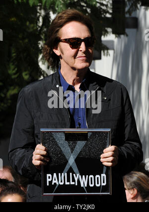 Former Beatle Paul McCartney holds a special plaque presented by Hollywood Chamber of Commerce President and CEO Leon Gubler as McCartney was honored with the 2,460th star on the Hollywood Walk of Fame, during an unveiling ceremony in Los Angeles on February 9, 2012.  UPI/Jim Ruymen Stock Photo