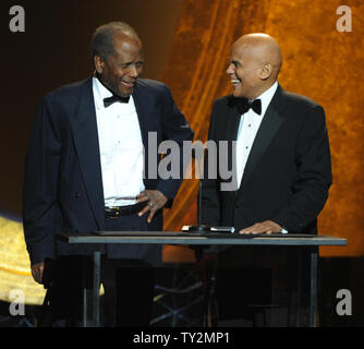 Presenters Sidney Poitier (L) and Harry Belafonte speak onstage during the 43rd NAACP Image Awards held at the Shrine Auditorium in Los Angeles on February 17, 2012.   UPI/Jim Ruymen Stock Photo