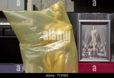 A gust of wind reveals a large Oscar statue covered for inclement weather in preparation for the red carpet near the main entrance for the 84th Academy Awards at the Kodak Theater in the Hollywood section of Los Angeles on February 25, 2012.   UPI/Gary C. Caskey Stock Photo