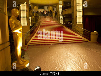 A Oscar statue stands guard on a covered red carpet near the stairway leading into the theater in preparation for the 84th Academy Awards at the Kodak Theater in the Hollywood section of Los Angeles on February 25, 2012.   UPI/Gary C. Caskey Stock Photo