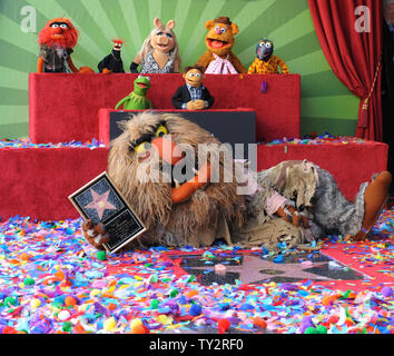 Muppets Animal, Pepe, Miss Piggy, Fozzie, Gonzo, (L-R, rear) and Kermit, Walter and Sweetums attend the Inimitable Muppets unveiling ceremony honoring The Muppets  with the 2,466th star on the Hollywood Walk of Fame in Los Angeles on March 20, 2012. UPI/Jim Ruymen Stock Photo