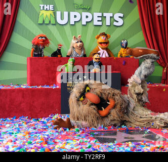 Muppets Animal, Pepe, Miss Piggy, Fozzie, Gonzo, (L-R, rear) and Kermit, Walter and Sweetums attend the Inimitable Muppets unveiling ceremony honoring The Muppets  with the 2,466th star on the Hollywood Walk of Fame in Los Angeles on March 20, 2012. UPI/Jim Ruymen Stock Photo