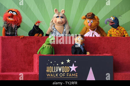 Muppets Animal, Pepe, Miss Piggy, Fozzie, Gonzo, (L-R, rear) and Kermit and Walter (L-R), foreground) attend the Inimitable Muppets unveiling ceremony honoring The Muppets  with the 2,466th star on the Hollywood Walk of Fame in Los Angeles on March 20, 2012. UPI/Jim Ruymen Stock Photo