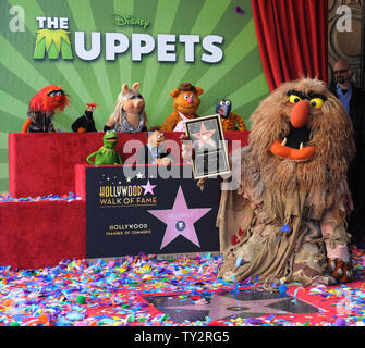 Muppets Animal, Pepe, Miss Piggy, Fozzie, Gonzo, (L-R, rear) and Kermit, Walter and Sweetums (L-R, foreground) attend the Inimitable Muppets unveiling ceremony honoring The Muppets  with the 2,466th star on the Hollywood Walk of Fame in Los Angeles on March 20, 2012. UPI/Jim Ruymen Stock Photo