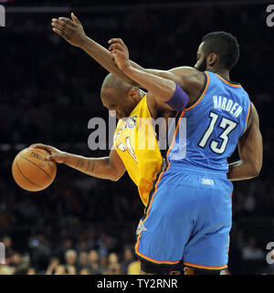 Los Angeles Lakers shooting guard Kobe Bryant (24) tries to go around Oklahoma City Thunder guard James Harden (13) in the first half of an NBA basketball game in Los Angeles on March 29, 2012.    UPI/Lori Shepler Stock Photo