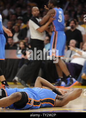 Oklahoma City Thunder guard James Harden (13) is knocked to the floor after getting hit by Los Angeles Lakers small forward Metta World Peace (15) in the first half of an NBA basketball game in Los Angeles on April 22, 2012.    UPI/Lori Shepler Stock Photo
