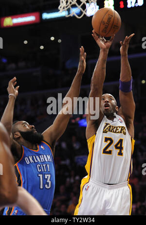 Los Angeles Lakers shooting guard Kobe Bryant (24) makes a basket over Oklahoma City Thunder guard James Harden (13) in the first half of an NBA basketball game in Los Angeles on April 22, 2012.    UPI/Lori Shepler Stock Photo