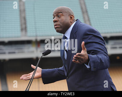 Former Los Angeles Dodger Steve Garvey presents Irvin Magic Johnson with  his Dodger jersey as the new owners of the Los Angeles Dodgers, known as  the Guggenheim Baseball Management Team, hold a