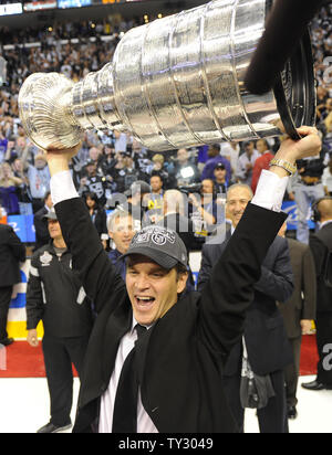 Former Los Angeles Kings' Luc Robitaille is greeted by fans as he walks  onto the ice at Staples Center during a ceremony retiring his jersey  number, 20, Saturday, Jan. 20, 2007, in