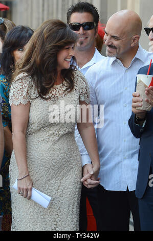 Television personality Valerie Bertinelli (L) shares a moment with her husband Tom Vitale (R), during an unveiling ceremony honoring her with the 2,476th star on the Hollywood Walk of Fame in Los Angeles on August 22, 2012.   UPI/Jim Ruymen Stock Photo