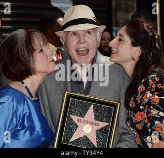 Actor Walter Koenig holds a replica plaque as he is kissed by his wife Judy Levitt (L) and daughter Danielle Koenig, during an unveiling ceremony honoring him with the 2,479th star on the Hollywood Walk of Fame in Los Angeles on September 10, 2012.  Koenig is the final member of the 'Star Trek' television show to receive a star.   UPI/Jim Ruymen Stock Photo