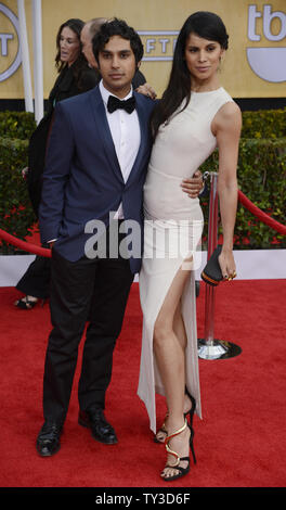 Actor Kunal Nayyar (L)and model Neha Kapur arrive for the 19th Annual SAG Awards held at the Shrine Auditorium in Los Angeles on on January 27, 2013.   UPI/Phil McCarten Stock Photo