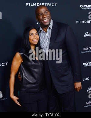 Earvin 'Magic' Johnson and his wife Cookie attend the premiere of the motion picture thriller 'Olympus Has Fallen',  at the ArcLight Cinerama Dome in the Hollywood section of Los Angeles on March 18, 2013. In a national security thriller, Antoine Fuqua directs an all-star cast featuring Gerard Butler, Morgan Freeman, Angela Bassett, Melissa Leo, Ashley Judd and Rick Yune. UPI/Jim Ruymen Stock Photo