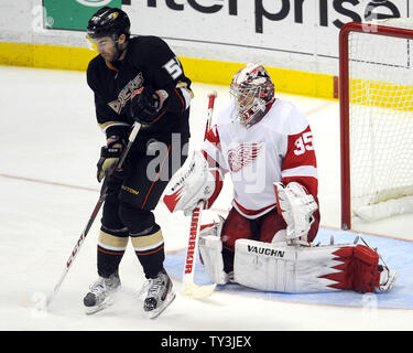 Anaheim Ducks right wing Kyle Palmieri (51) takes a shot to the body as Detroit Red Wings goalie Jimmy Howard (35) defends in the third period at the Honda Center in Anaheim, California on March 24, 2013.  The Red Wings won 2-1. UPI/Lori Shepler. Stock Photo