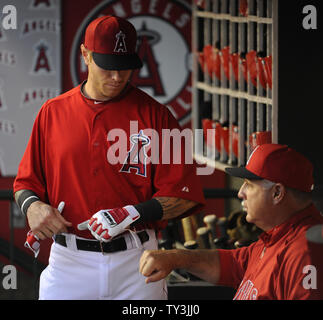 Los Angeles Dodgers Mike Scioscia, left, and Steve Sax, right, mob teammate  Orel Hershiser after Hershiser pitched a five hitter and shut out the New  York Mets to claim the National League