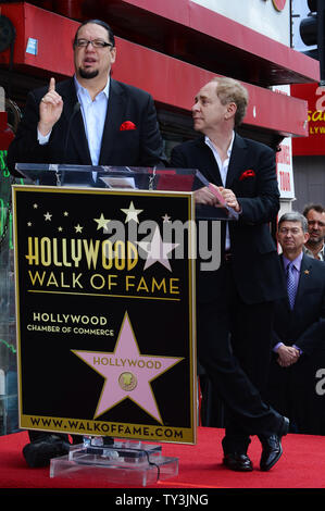 Penn Jillette (L) and Raymond Teller of the comedy magic duo Penn & Teller make comments, during an unveiling ceremony, honoring the pair with the 2,494th star on the Hollywood Walk of Fame in Los Angeles on April 5, 2013.  UPI/Jim Ruymen Stock Photo