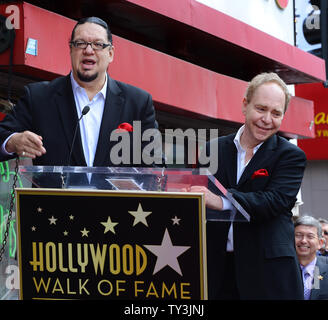 Penn Jillette (L) and Raymond Teller of the comedy magic duo Penn & Teller make comments, during an unveiling ceremony, honoring the pair with the 2,494th star on the Hollywood Walk of Fame in Los Angeles on April 5, 2013.  UPI/Jim Ruymen Stock Photo