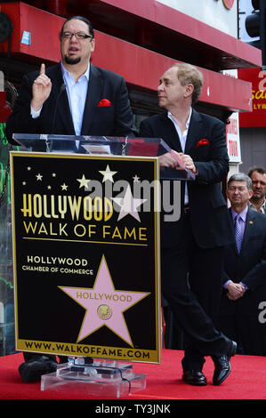 Penn Jillette (L) and Raymond Teller of the comedy/magic duo Penn & Teller make comments, during an unveiling ceremony, honoring the pair with the 2,494th star on the Hollywood Walk of Fame in Los Angeles on April 5, 2013.  UPI/Jim Ruymen Stock Photo