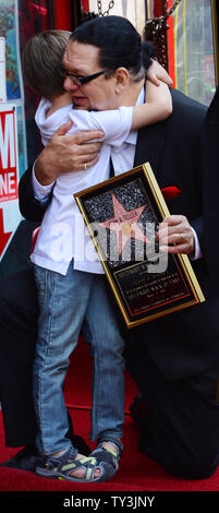 Penn Jillette  of the comedy/magic duo Penn & Teller is hugged by his son Zolten, during an unveiling ceremony, honoring the pair with the 2,494th star on the Hollywood Walk of Fame in Los Angeles on April 5, 2013.   UPI/Jim Ruymen Stock Photo