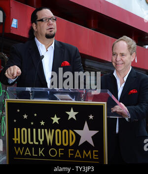 Penn Jillette (L) and Raymond Teller of the comedy/magic duo Penn & Teller make comments, during an unveiling ceremony, honoring the pair with the 2,494th star on the Hollywood Walk of Fame in Los Angeles on April 5, 2013.  UPI/Jim Ruymen Stock Photo