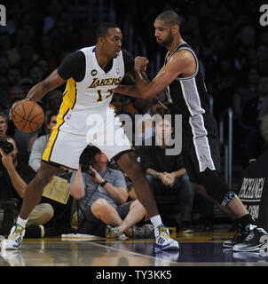 Los Angeles Lakers center Dwight Howard (12) takes the ball past San Antonio Spurs power forward Tim Duncan, right, in the first half at Staples Center in Los Angeles on April 14, 2013. UPI/Lori Shepler Stock Photo