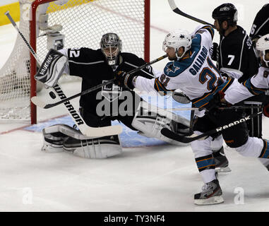 San Jose Sharks left wing T.J. Galiardi (21) redirects the puck as Los Angeles Kings goalie Jonathan Quick (32) and defenseman Rob Scuderi (7) defend during the second period of Game 1 of the Western Conference semifinals at Staples Center in Los Angeles on May 14, 2013. UPI/Alex Gallardo Stock Photo