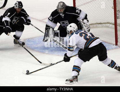 San Jose Sharks left wing T.J. Galiardi (21) takes a shot with Los Angeles Kings goalie Jonathan Quick (32) and defenseman Rob Scuderi (7) defending during the first period of Game 1 of the Western Conference Playoffs at Staples Center in Los Angeles on May 14, 2013. UPI/Alex Gallardo Stock Photo