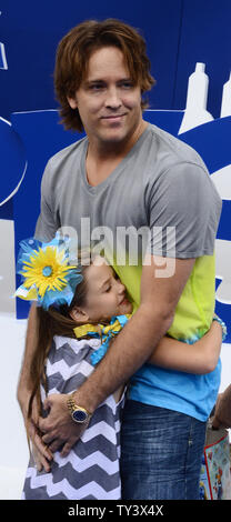 Larry Birkhead (R) and Dannielynn Marshall, his daughter with model Anna Nicole Smith attend the premiere of his new motion picture animated comedy 'The Smurfs 2', at the Regency Village Theatre, in the Westwood section of Los Angeles on July 28, 2013. The Smurfs join forces with their human friends to rescue Smurfette, who has been kidnapped by Gargamel since she knows a secret spell that can turn the evil sorcerer's newest creation - creatures called the Naughties - into real Smurfs.  UPI/Jim Ruymen Stock Photo