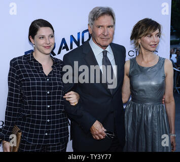 Cast member Harrison Ford attends the premiere of the motion picture thriller 'Paranoia', with his daughter Georgia Ford (L) and wife, actress Calista Flockhart (R) at the DGA Theatre in the Hollywood section of Los Angeles on August 8, 2013. The film depicts the story of the two most powerful high tech billionaires in the world, bitter rivals who will stop at nothing to destroy each other.   UPI/Jim Ruymen Stock Photo