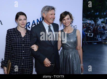 Cast member Harrison Ford attends the premiere of the motion picture thriller 'Paranoia', with his daughter Georgia Ford (L) and wife, actress Calista Flockhart (R) at the DGA Theatre in the Hollywood section of Los Angeles on August 8, 2013. The film depicts the story of the two most powerful high tech billionaires in the world, bitter rivals who will stop at nothing to destroy each other.   UPI/Jim Ruymen Stock Photo