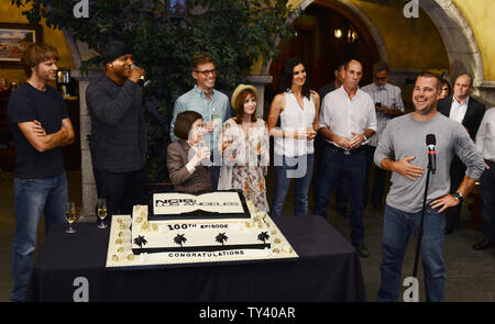 Cast members Eric Christian Olsen, L.L. Cool J, Linda Hunt, Barrett Foa, Renee Felice Smith, Daniela Ruah and Miguel Ferrer (L-R), listen to remarks by cast member Chris O'Donnell, during a cake-cutting ceremony to celebrate CBS' 'NCIS: Los Angeles' filming of their 100th episode held on the set at Paramount Studios in Los Angeles on August 23, 2013.  UPI/Jim Ruymen Stock Photo