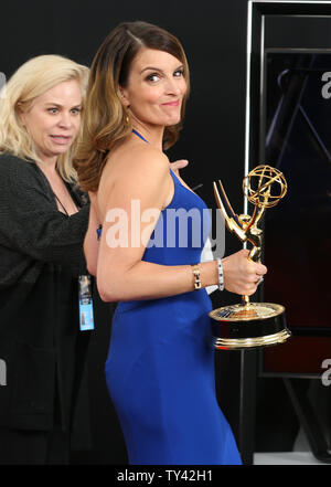 Actress/writer Tina Fey holds the award she won for  'Outstanding Writing for a Comedy Series - 30 Rock (Last Lunch) ' at the 65th Primetime Emmy Awards at Nokia Theatre in Los Angeles on September 22, 2013.   UPI/Danny Moloshok Stock Photo