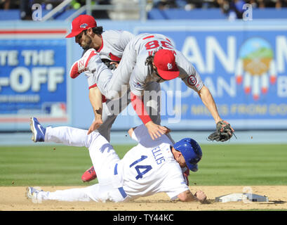 St. Louis Cardinals second baseman Matt Carpenter and shortstop Pete Kozma collide on the successful double play at second base as Los Angeles Dodgers Mark Ellis (14) slides into them in the 3rd inning of Game 5 of the National League Championship Series at Dodger Stadium in Los Angeles on October 16, 2013. UPI/Lori Shepler Stock Photo