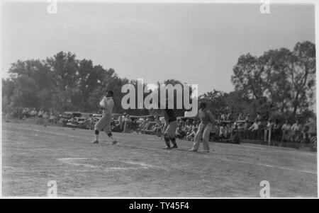 Fans surround the field to watch a baseball game in progress Stock Photo
