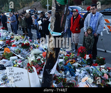 Fans gather at a makeshift memorial to pay respects at the site of the fiery car accident in which actor Paul Walker was killed in Santa Clarita, California, on December 4, 2013. Fans and fellow actors mourned the death of Paul Walker, who died in a fiery car crash on Saturday, December 1, 2013. Walker, 40, who was best known as undercover agent Brian O'Connor in the 'Fast and Furious' action movies, appeared in all but one of the six movies in the popular franchise, and was a leading protagonist along with Vin Diesel and Michelle Rodriguez. UPI/Jim Ruymen Stock Photo