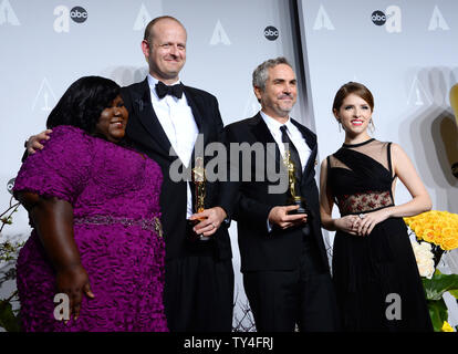 Actress Gabourey Sidibe, Film Editor Mark Sanger and Director Alfonso Cuaron hold the awards they won for Best Achievement in Film Editing for 'Gravity'  and actress Anna Kendrick backstage during the 86th Academy Awards at the Hollywood & Highland Center on March 2, 2014 in the Hollywood section of Los Angeles. UPI/Jim Ruymen Stock Photo