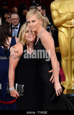 Actress Charlize Theron (R) and her mother Gerda Maritz arrive on the red carpet at the 86th Academy Awards at the Hollywood and Highland Center in the Hollywood section of Los Angeles on March 2, 2014. UPI/Jim Ruymen Stock Photo