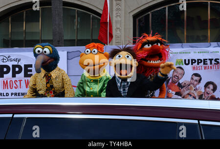 Muppet characters The Great Gonzo, Scooter, Walter and Animal (L-R) attend the premiere of the motion picture comedy 'Muppets Most Wanted' at the El Capitan Theatre in the Hollywood section of Los Angeles on March 11, 2014. Storyline: While on a grand world tour, The Muppets find themselves wrapped into an European jewel-heist caper headed by a Kermit the Frog look-alike and his dastardly sidekick.  UPI/Jim Ruymen Stock Photo