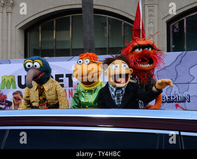 Muppet characters The Great Gonzo, Scooter, Walter and Animal (L-R) attend the premiere of the motion picture comedy 'Muppets Most Wanted' at the El Capitan Theatre in the Hollywood section of Los Angeles on March 11, 2014. Storyline: While on a grand world tour, The Muppets find themselves wrapped into an European jewel-heist caper headed by a Kermit the Frog look-alike and his dastardly sidekick.  UPI/Jim Ruymen Stock Photo