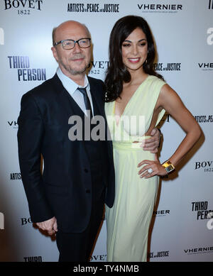 Director Paul Haggis and cast member Moran Atias attend the premiere of his new motion picture romantic drama 'Third Person' at the Pickford Center for Motion Picture Studio/Linwood Dunn Theatre in the Hollywood section of Los Angeles on June 9, 2014. 'Third Person' tells the interlocking stories of love, passion, trust and betrayal involving three couples in three cities: Rome, Paris and New York.   UPU/Jim Ruymen Stock Photo