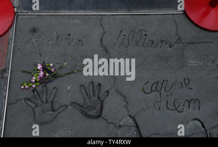 Actor Robins Williams handprints and signature are on display in the forecourt of TCL Chinese Theatre in Los Angeles on August 12, 2014. The Latin phrase carpe diem, lower right, that translates to 'seize the day' was written in wet cement by Williams during a 1998 hand & footprint ceremony. Williams uttered the phrase in the the film 'Dead Poets Society'. Williams was found dead in his Marin County, California home on August 11, 2014. He was 63.   UPI/Jim Ruymen Stock Photo